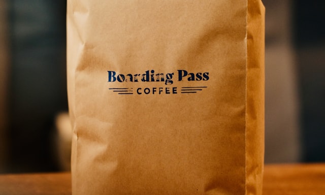 A bag of roasted coffee beans on a wooden table