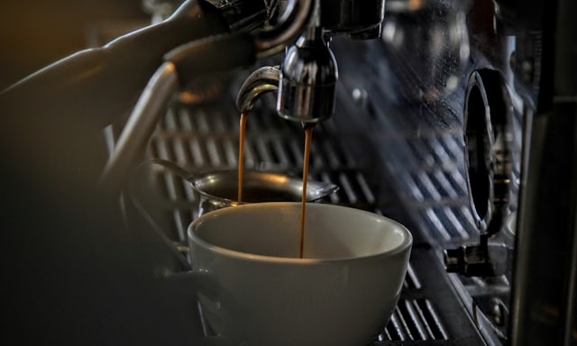 Espresso pouring from an espresso machine into a cup