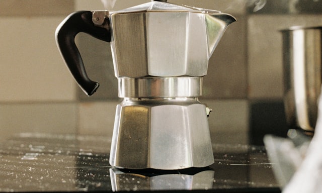 A clean aluminium moka pot on a kitchen worktop